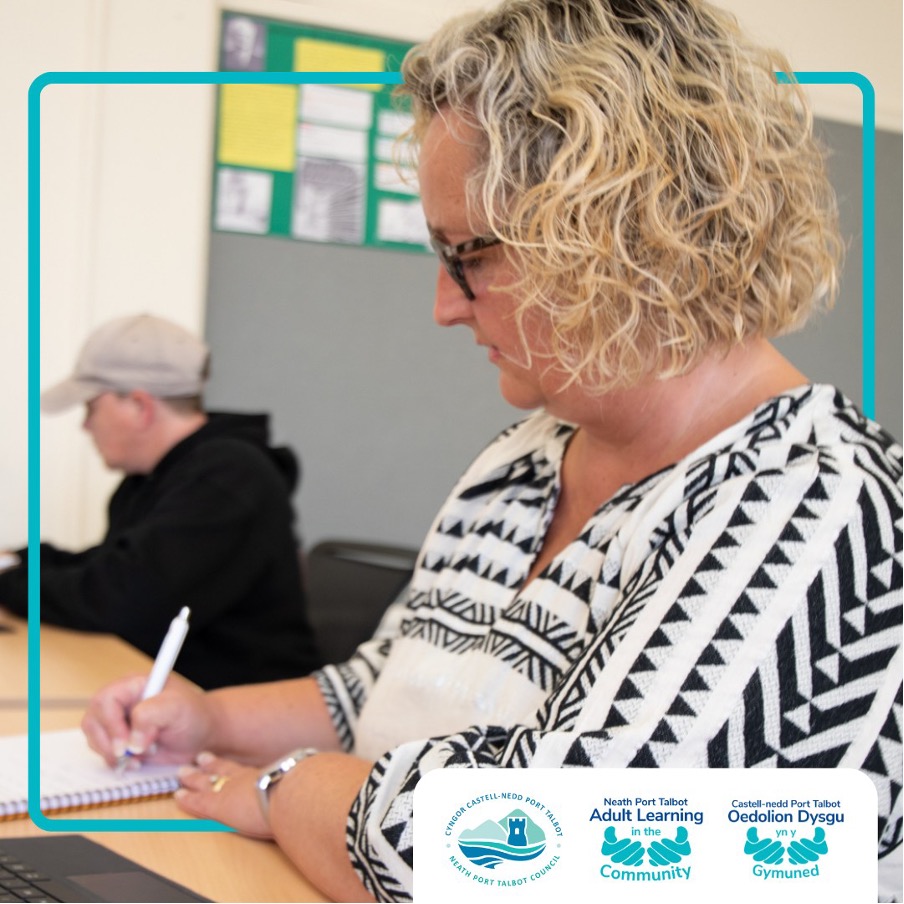 An adult learner taking notes in a lesson