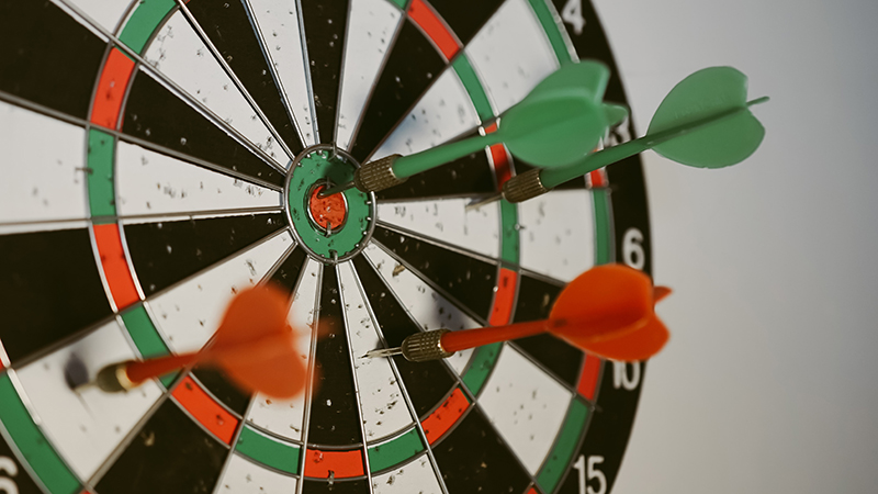 Dartboard image with darts in the board
