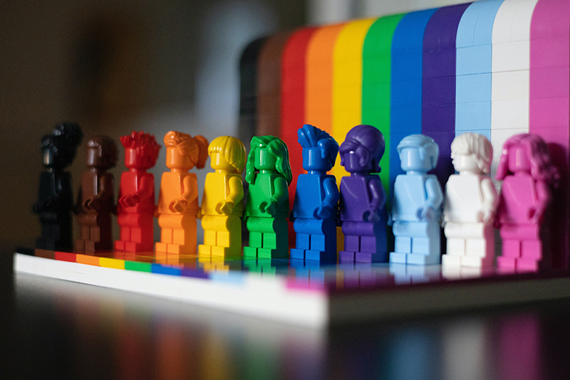 a line of rainbow coloured lego figures