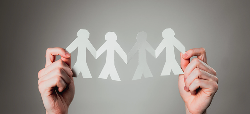 cut out of paper dolls holding hands